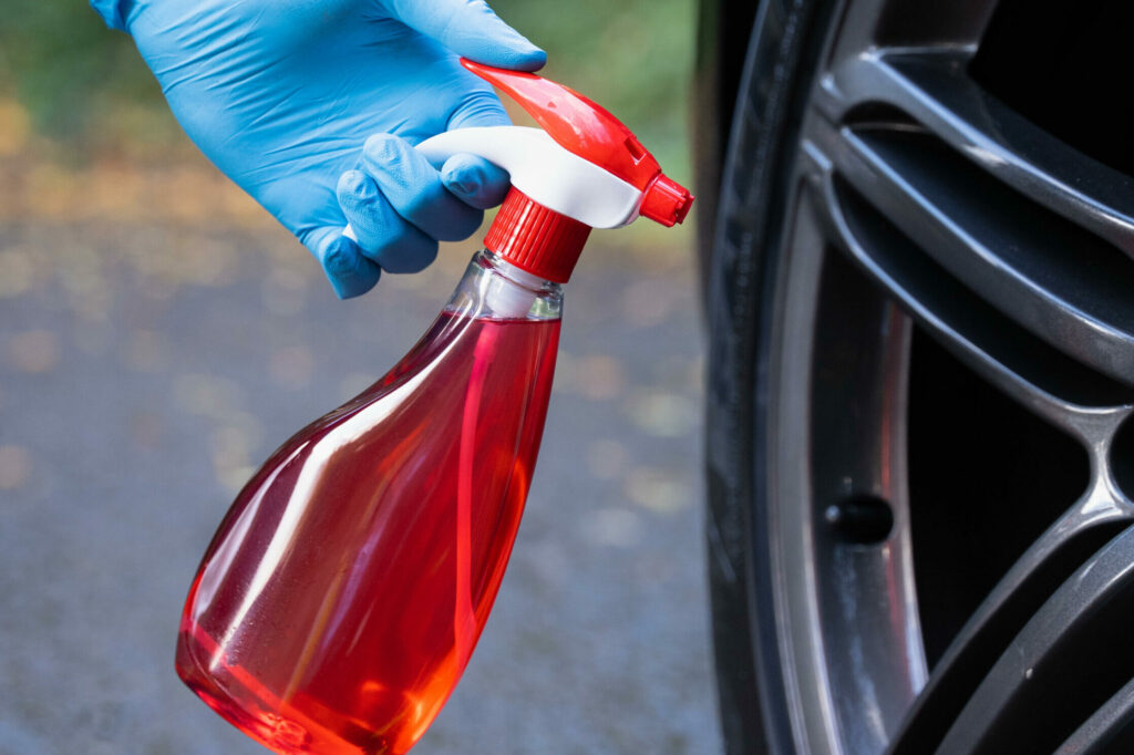 Poseidon thumb sprayer in front of car wheel automotive